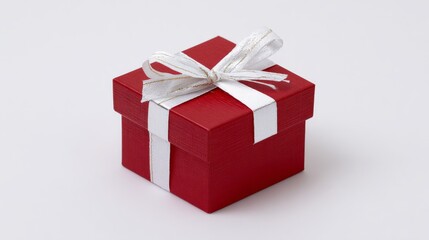Obraz premium A vibrant red gift box with a large white satin ribbon tied in an elegant bow, set against a clean white background,