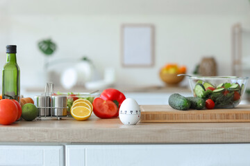 Modern kitchen timer with food on table in room, closeup
