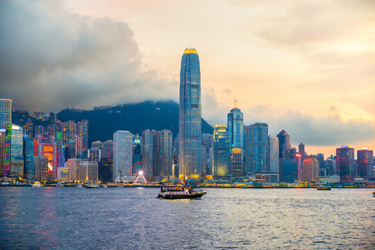 Hong Kong cityscape skyline at sunset night sky across Victoria harbor. One of the most tourist attaction in Hong Kong Island, China.