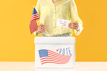 Woman putting paper with text YOUR VOTE MATTERS in ballot box and USA flag on yellow background