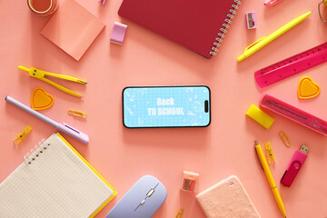 Mobile phone with text BACK TO SCHOOL and stationery on pink background