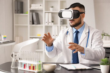 Male doctor using VR glasses at table in office
