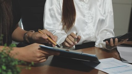 Financial analysts analyze business financial reports on a digital tablet planning investment project during a discussion at a meeting of corporate showing the results of their successful teamwork. - Powered by Adobe