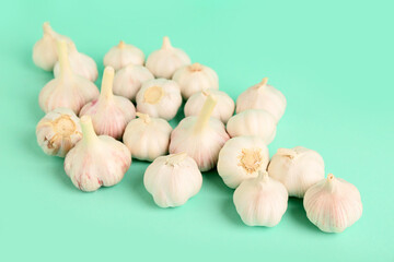 Many fresh garlics on turquoise background