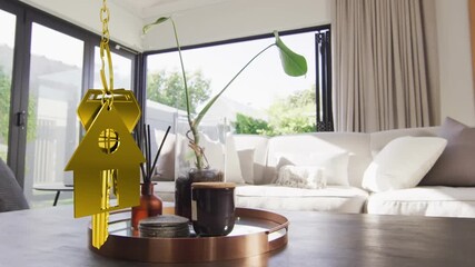 Animation of golden house and key over living room - Powered by Adobe