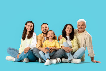 Fototapeta premium Portrait of big family sitting on blue background