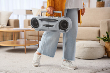 Senior woman with boombox at home