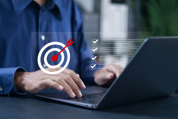 Business strategy planning concept. Businessman using laptop with target goal icon with correct...