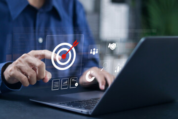 Fototapeta premium Project task management and business strategy planning concept. Businessman using laptop with business goals and effective time planning for project development.