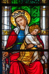 Stained glass (19th century) of Blessed Virgin Mary holding baby Jesus Christ in her arms.