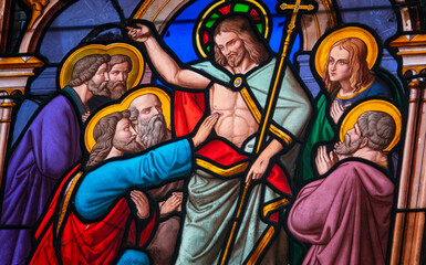Stained (19th century) glass of Saint Thomas the Apostle touching the wounds of Christ.