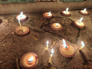 Glow of the candlelight on ground base of Thai temple for celebration and worship