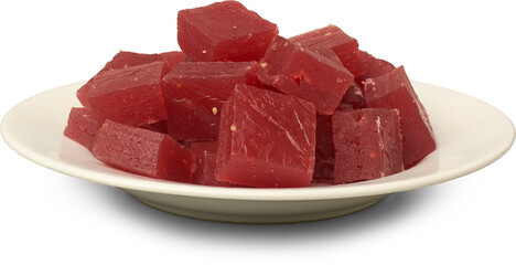 plate of red ghee musket or karachi halwa pieces isolated white background, aka bombay halva, traditional sri lankan or indian chewy sweet dessert 