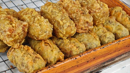 Deep fried unripe rice grain.