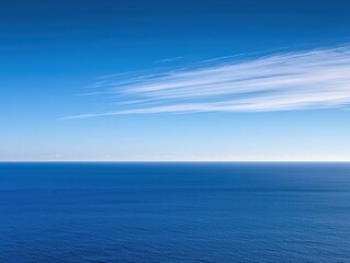 Obraz premium Serene Blue Ocean Under Clear Sky with Light Cloud Formation
