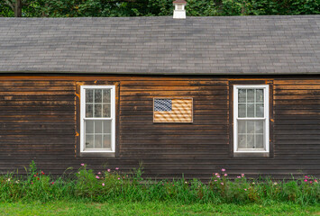 facade view of old farm house with USA flag on the wall © nd700