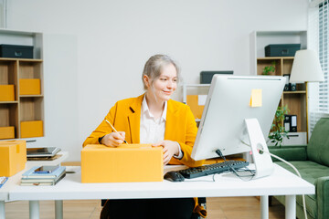 Young female entrepreneur running an SME, packing products, managing online store, shipping orders, and working from home. Perfect for ecommerce, delivery, and business themes.