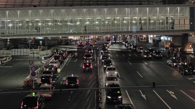Night in Tokyo : Walking along the Pedestrian Skywalk over the Highway at Shibuya Station. Motorcade on this Way, Crowds at the Crossing, Lines of Taxis on Both Sides  |  Shibuya, Tokyo, Japan