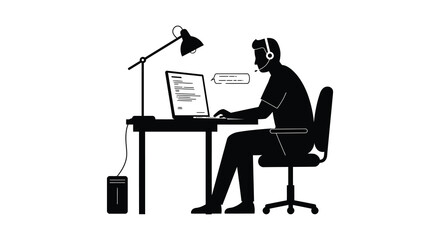 Man wearing headset working on laptop at desk with lamp