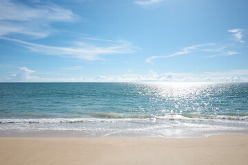 Beach with soft sand blue green sea with little wave and reflex of sun ray on horizontal line