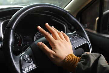 The driver is honking the horn to prevent an accident.