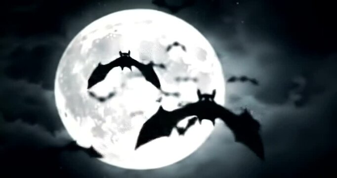 Silhouettes of bats flying in front of a large full moon on a cloudy night.