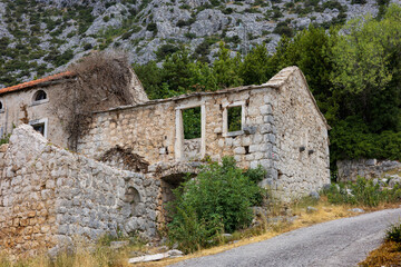 Ruins of an old stone house in an abandoned village. The photo makes you think about the meaning of...