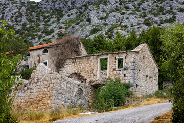 Ruins of an old stone house in an abandoned village. The photo makes you think about the meaning of...