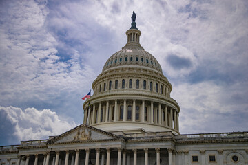 Naklejka premium Congress in Washington, DC. The Capitol dome over Capitol Hill. Washington, DC landmark. American flag above the Congress. Washington DC skyline. Senate and House in Washington, DC.