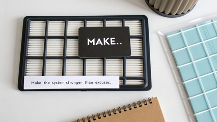 Creative workspace elements featuring motivational card and stationery