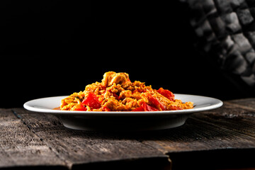 Omelette with tomatoes on a dark background.Asian food. Chinese cuisine