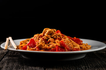 Omelette with tomatoes on a dark background.Asian food. Chinese cuisine