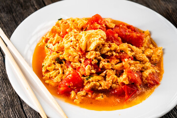 Omelette with tomatoes on a dark background.Asian food. Chinese cuisine