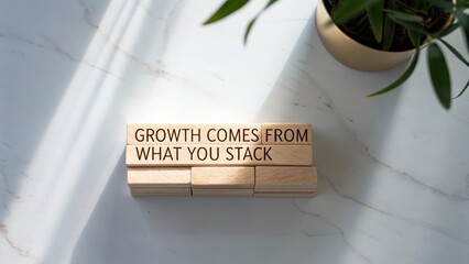 Inspirational message on wooden blocks with natural light and plant background