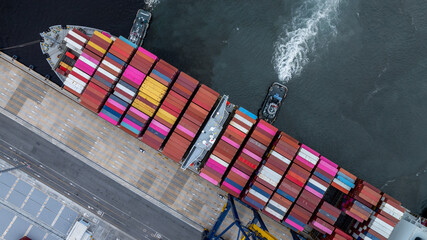 Aerial view container cargo ship at port with tugboat, Business global import export logistic...