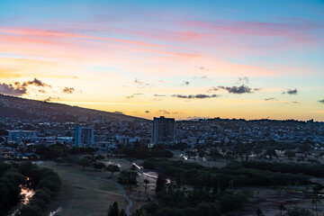 Sunrise (or sunup) is the moment when the upper rim of the Sun appears on the horizon in the morning. Waikiki, Honolulu, Oahu, Hawaii. Ala Wai Golf Course. Ala Wai Canal