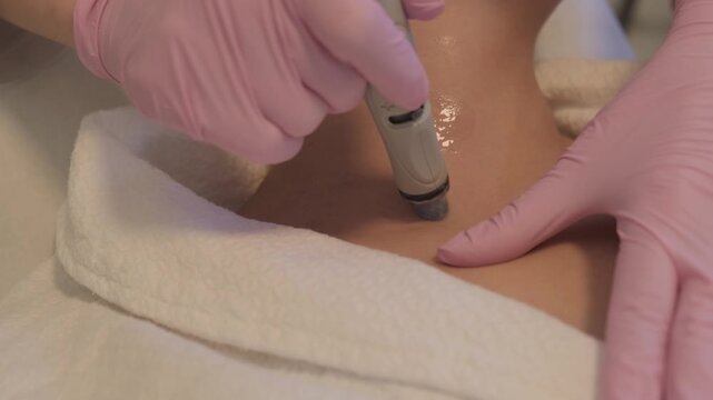 Vacuum cleaning and polishing face and neck of a young woman in cosmetology clinic. Effective hydration and skin rejuvenation using modern technologies for the perfect facial care.