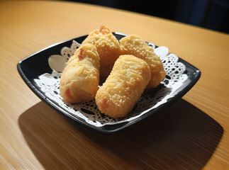 Crispy Deep-Fried Spring Rolls on a Black Background