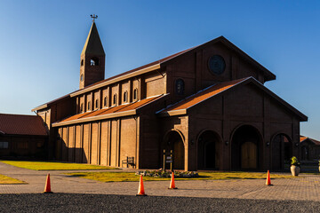 Fototapeta premium Facade of the church built with bricks in view of the Divina Misericordia Monastery, in rural area of ​​the Marilia, Sao Paulo state, Brazil