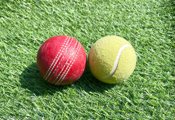 Cricket and Tennis Balls on Grass Field Sports Concept