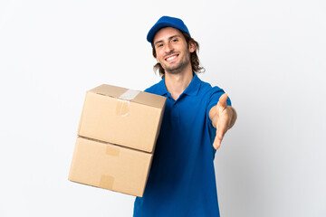 Delivery man isolated on white background shaking hands for closing a good deal