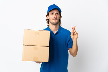 Delivery man isolated on white background with fingers crossing and wishing the best