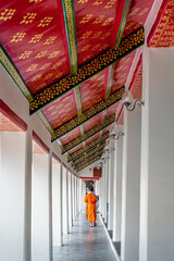 Monks are walking to practice meditation inside the temple.
