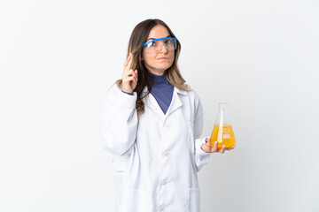 Young Romanian scientific woman isolated on white background with fingers crossing and wishing the...