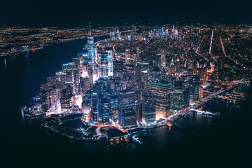 a city in night view with light surrounded by a lake