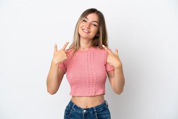 Young Romanian woman isolated on white background giving a thumbs up gesture