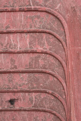 Macro Photography of old stacked red plastic chairs showing repeated curves graphic
