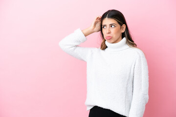 Fototapeta premium Young Italian woman isolated on pink background having doubts while scratching head