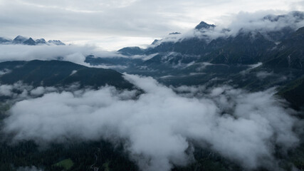 Aerial view of beautiful foggy forest and rocky  mountains landscape
