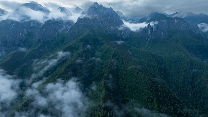 Fototapeta premium Aerial view of beautiful foggy forest and rocky mountains landscape